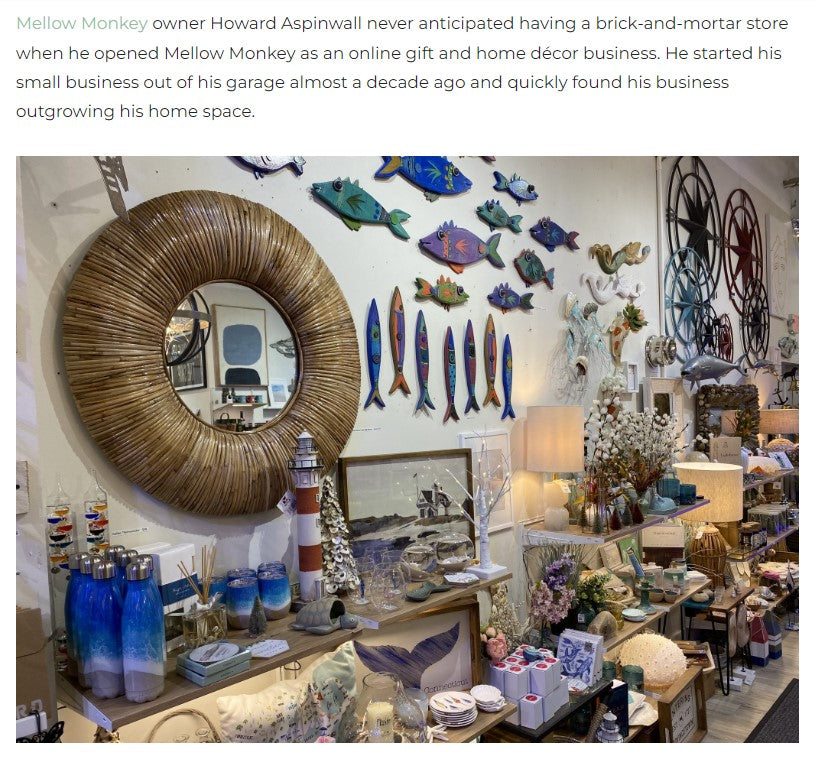 image of the wall in the store with a mirror and wood fish along with other decorative items. 