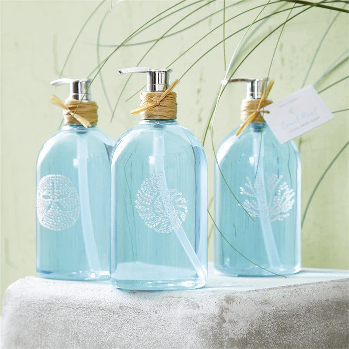three bottles of aqua colored liquid soap with pump on white stone counter
