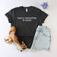 Black t-shirt with 'EASILY DISTRACTED BY ROCKS' text, sandals, and denim shorts on a light background