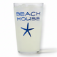 Mellow Monkey 16 oz pint glass featuring a navy blue starfish and Beach House text on a clear glass surface