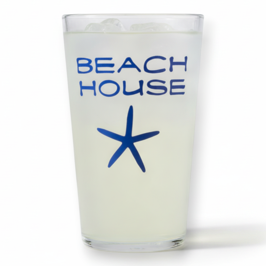 Mellow Monkey 16 oz pint glass featuring a navy blue starfish and Beach House text on a clear glass surface