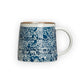 Mellow Monkey hand-stamped stoneware mug with blue floral design and gold rim detail. Microwave, dishwasher, and oven safe.
