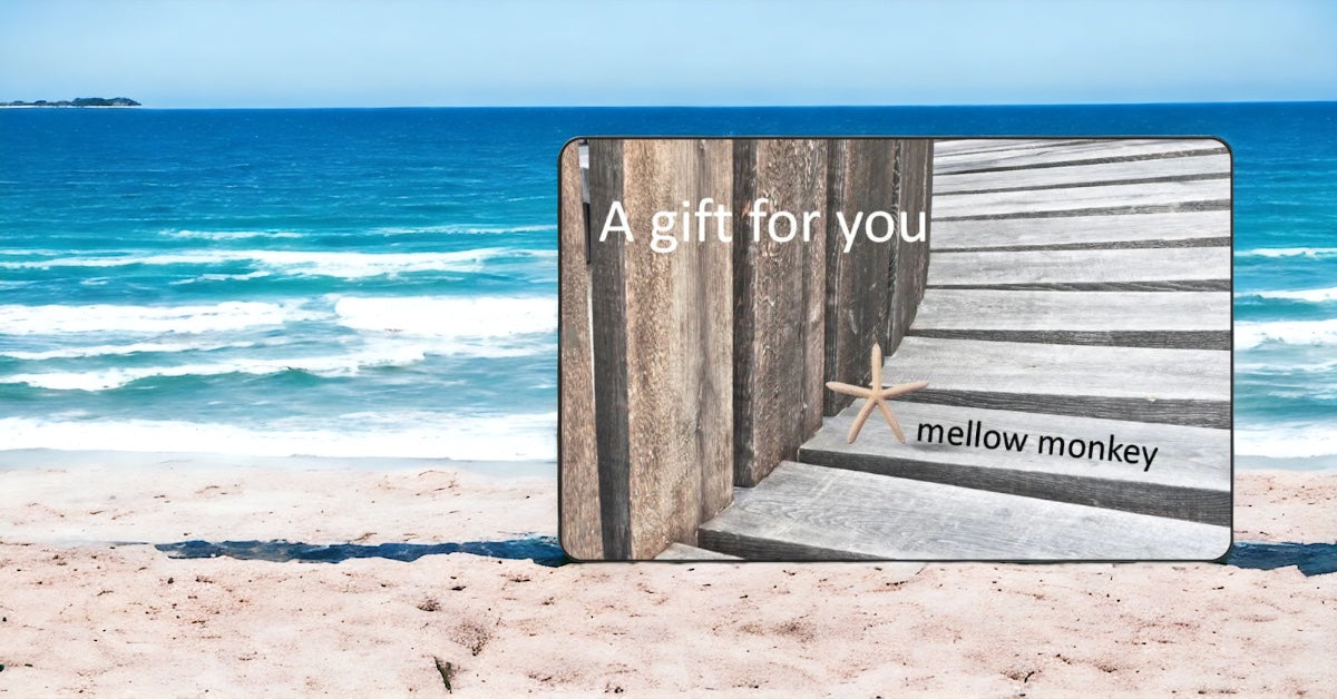 Mellow monkey gift card with text a gift for you is showing on the beach