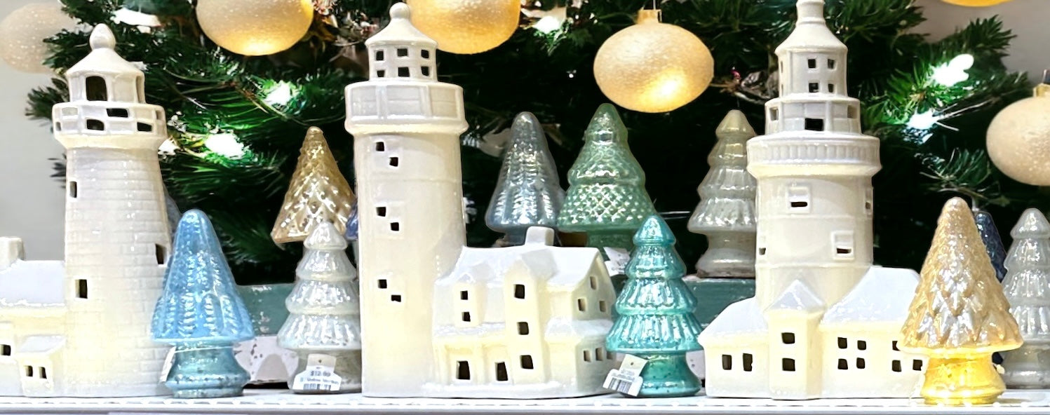 white ceramic lighthouses with scattered mercury glass trees