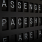 Vestaboard example display. white split flap letters on black background spelling out "passengers", "spaceship"  and "we are all"