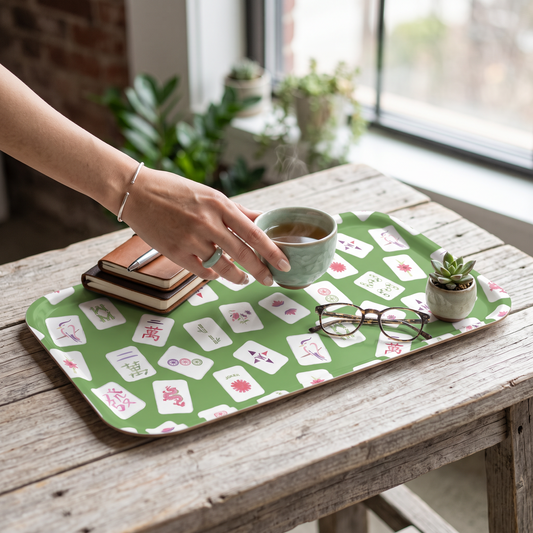 Mellow Monkey small serving tray with green Mahjong tile pattern on a rustic wooden table with tea and glasses