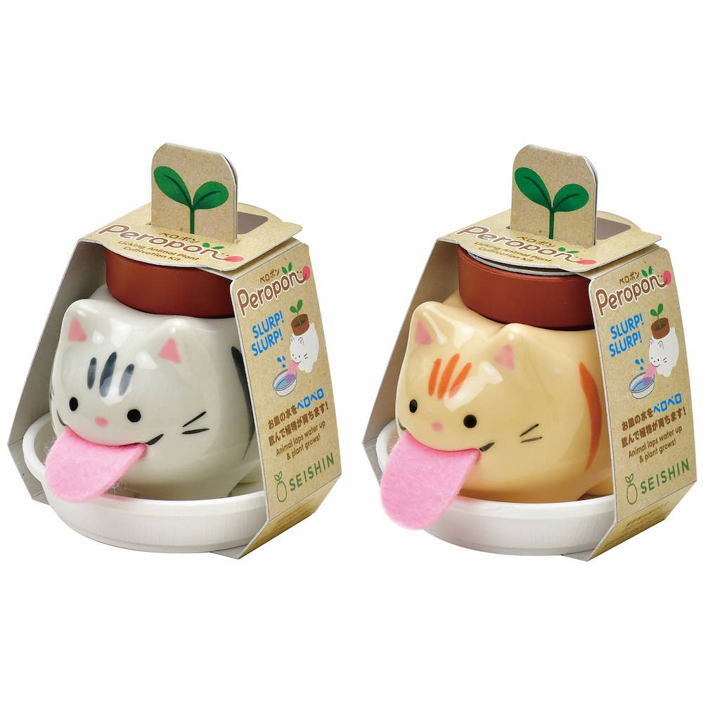 Two cat-shaped ceramic cups with packaging on a white background