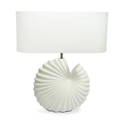 A white table lamp with a pleated, shell-like ceramic base and a matching white drum shade, shown against a plain white background.