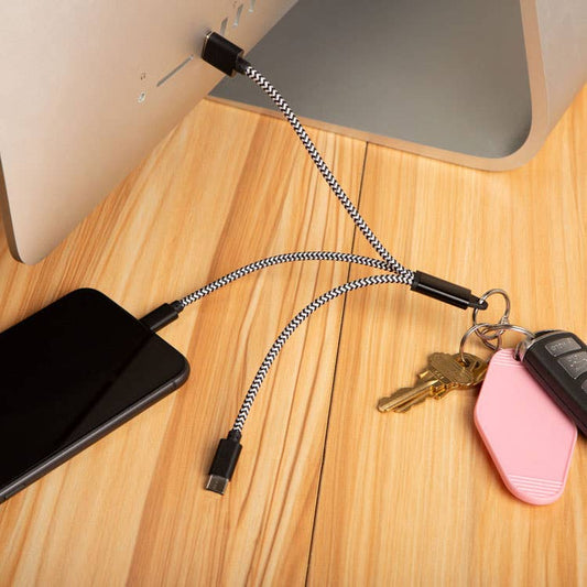 Mellow Monkey 3-in-1 charging keyring with black and white braided nylon cables connected to a phone and computer