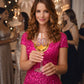 Mellow Monkey 30th birthday wine glass with a jeweled number 30 held by a woman in a sparkling pink dress at a party