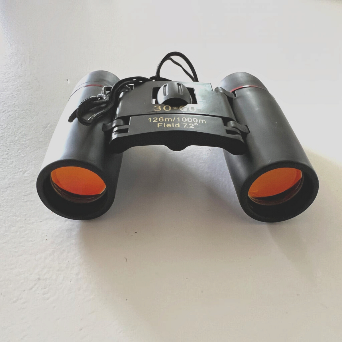 Mellow Monkey 30x60 compact folding binoculars with orange-tinted lenses for hunting, camping, and bird watching.
