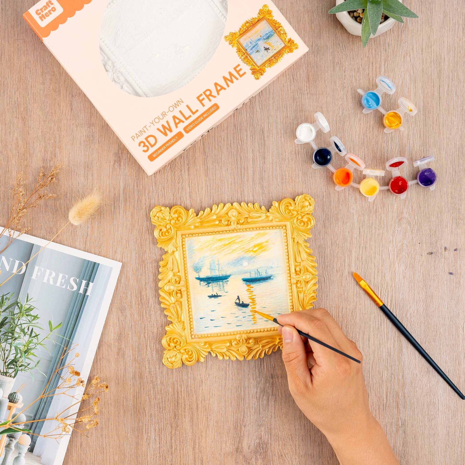 Mellow Monkey Muddies 3D wall frame painting kit featuring a pre-sculpted Monet Sunrise scene being painted by hand.