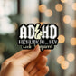 Mellow Monkey ADHD Hey Look A Squirrel waterproof vinyl sticker held in hand against a blurred bokeh background.