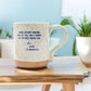 Mellow Monkey handmade ceramic mug with speckled finish and Alice in Wonderland quote on a wooden table