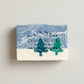 Mellow Monkey Alpine Frost handmade bar soap with blue and white marbled design and pine tree cutouts.
