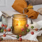 Mellow Monkey vintage amber glass tea light holder with embossed pattern glowing on a festive autumn table setting
