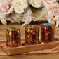Mellow Monkey vintage amber glass tea light holders filled with colorful candies on a wooden tray with floral decor