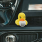 Mellow Monkey yellow rubber duck holding a coffee mug that says Running on Pure Anxiety on a car dashboard