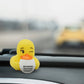 Mellow Monkey yellow rubber duck holding a coffee mug that says Running on Pure Anxiety on a car dashboard