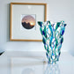 Mellow Monkey Aqua Samba 12-inch hand-painted Venetian glass vase in blue and green with a swirling pattern.