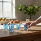 Mellow Monkey aqua Venetian glass shot glass with blue and green tree of life design. 2.5-oz capacity.