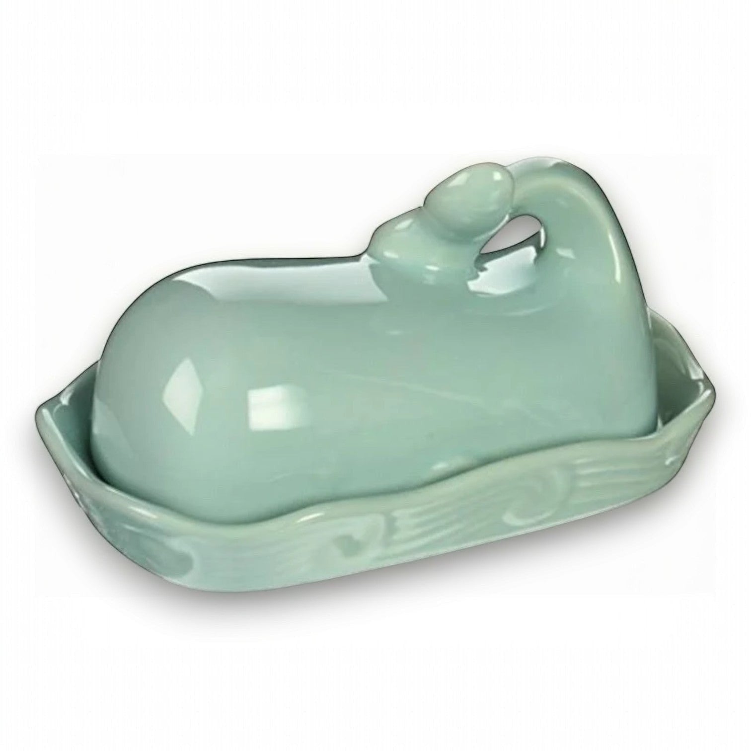 Mellow Monkey aqua ceramic whale butter dish with lid, featuring a tail handle and wave pattern on the dish.