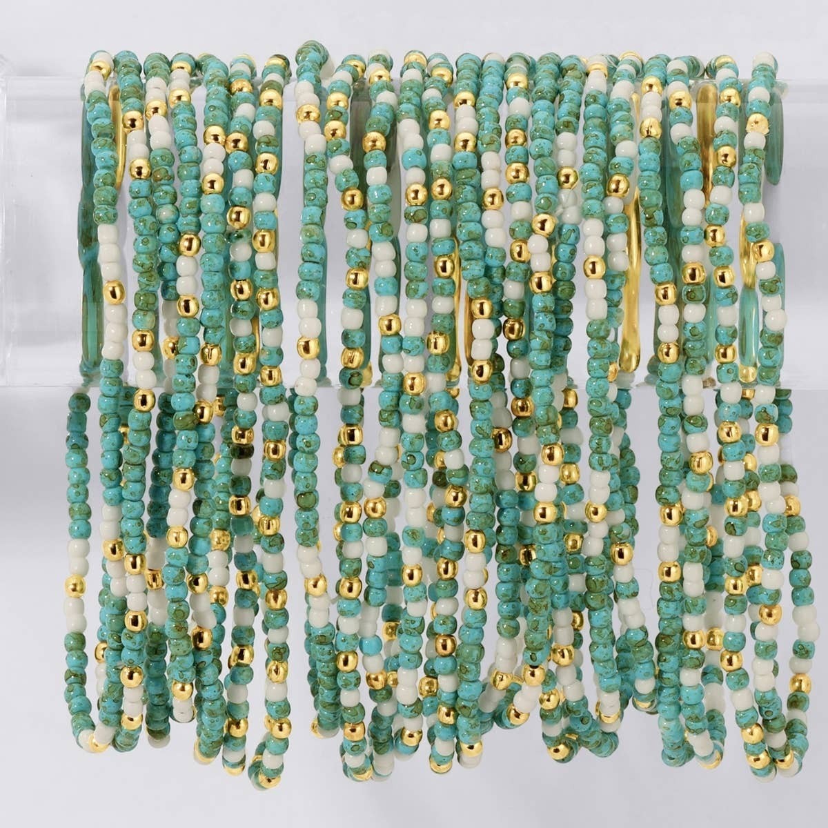 Mellow Monkey stretch seed bead bracelet set in aqua, white, and 18k gold plated brass for a layered, organic look.