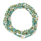 Mellow Monkey set of 8 stretch seed bead bracelets in aqua, white, and 18k gold plated brass for a stacked look.