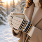 Mellow Monkey Aspen Fair Isle gloves in Cloud color with sweater knit texture holding a warm mug in a snowy forest.