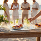 Mellow Monkey Large Acrylic Tray with Atlantic Reef art, serving drinks and tarts on a beach.