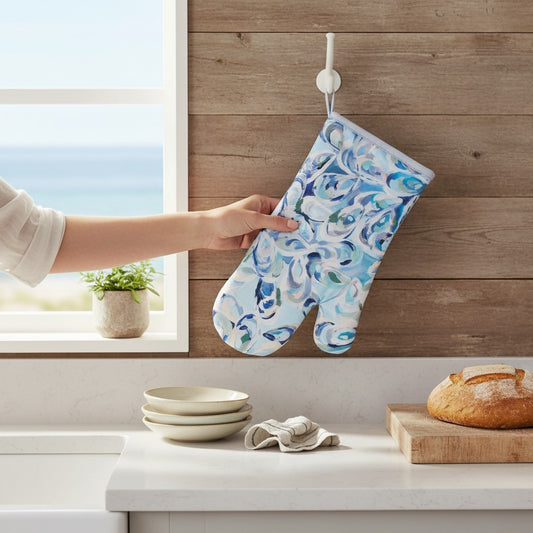 Mellow Monkey Atlantic Reef cotton oven mitt featuring blue and white abstract oyster shell art in a kitchen setting