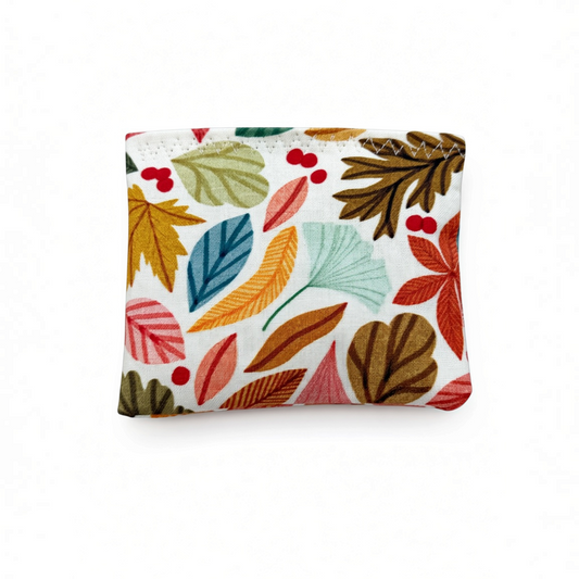 Mellow Monkey Mantra Beads sensory calm bag in an autumn leaves print with colorful foliage on a white background.
