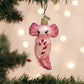 Mellow Monkey pink blown glass axolotl ornament holding a red and white candy cane, festive holiday decor