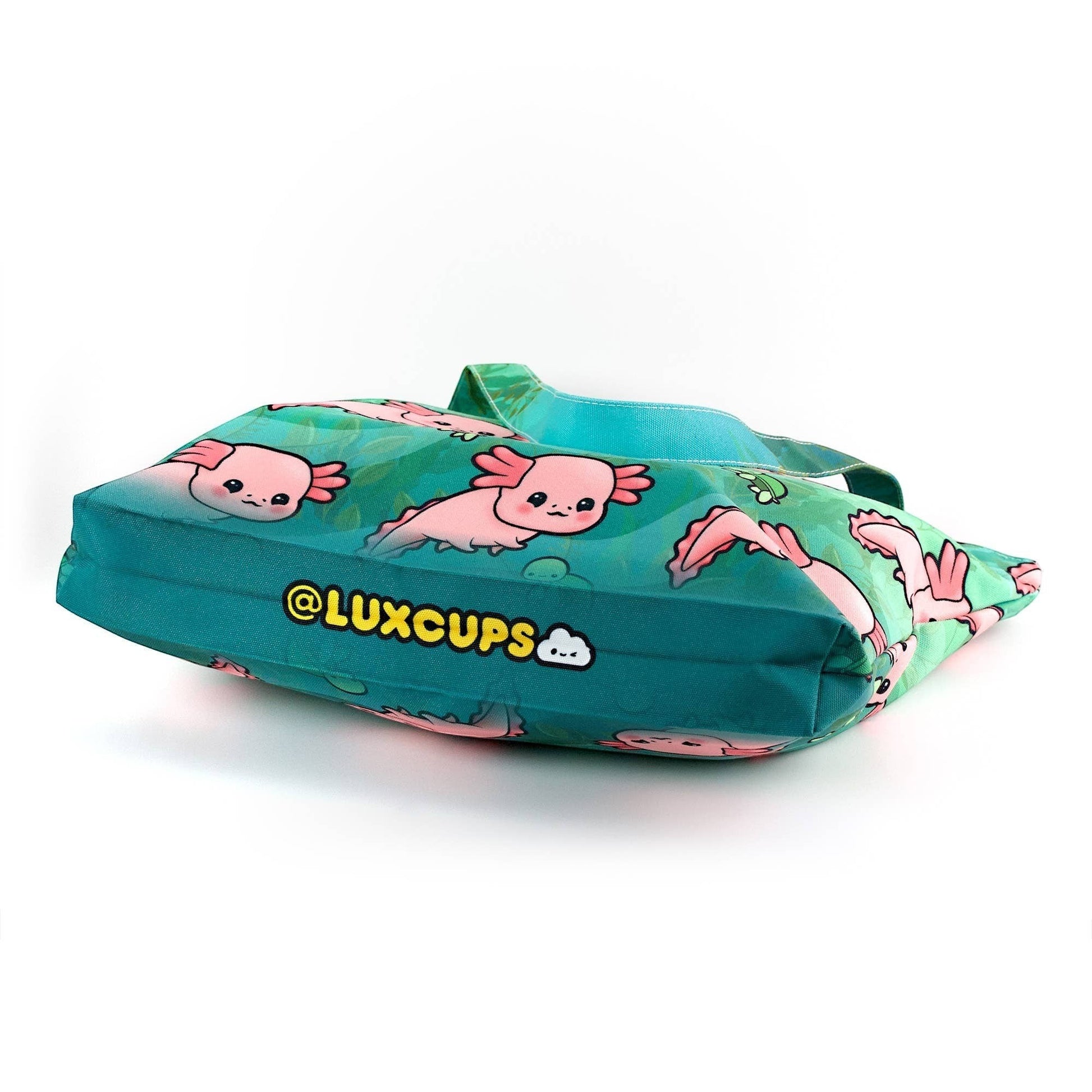 Mellow Monkey green canvas tote bag with pink axolotl print and teal straps. Features zippered closure and interior pocket.