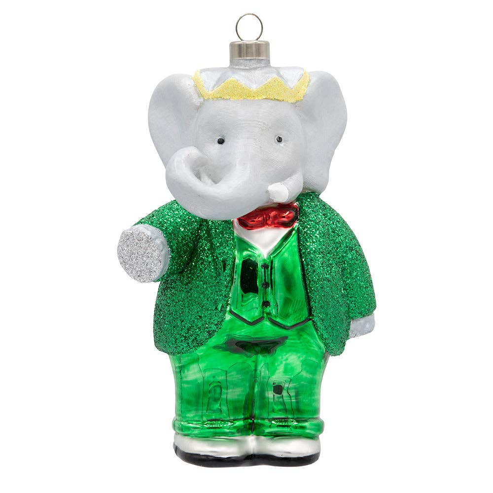 Mellow Monkey Babar the Elephant glass Christmas ornament wearing a green glittered suit, red bowtie, and gold crown.