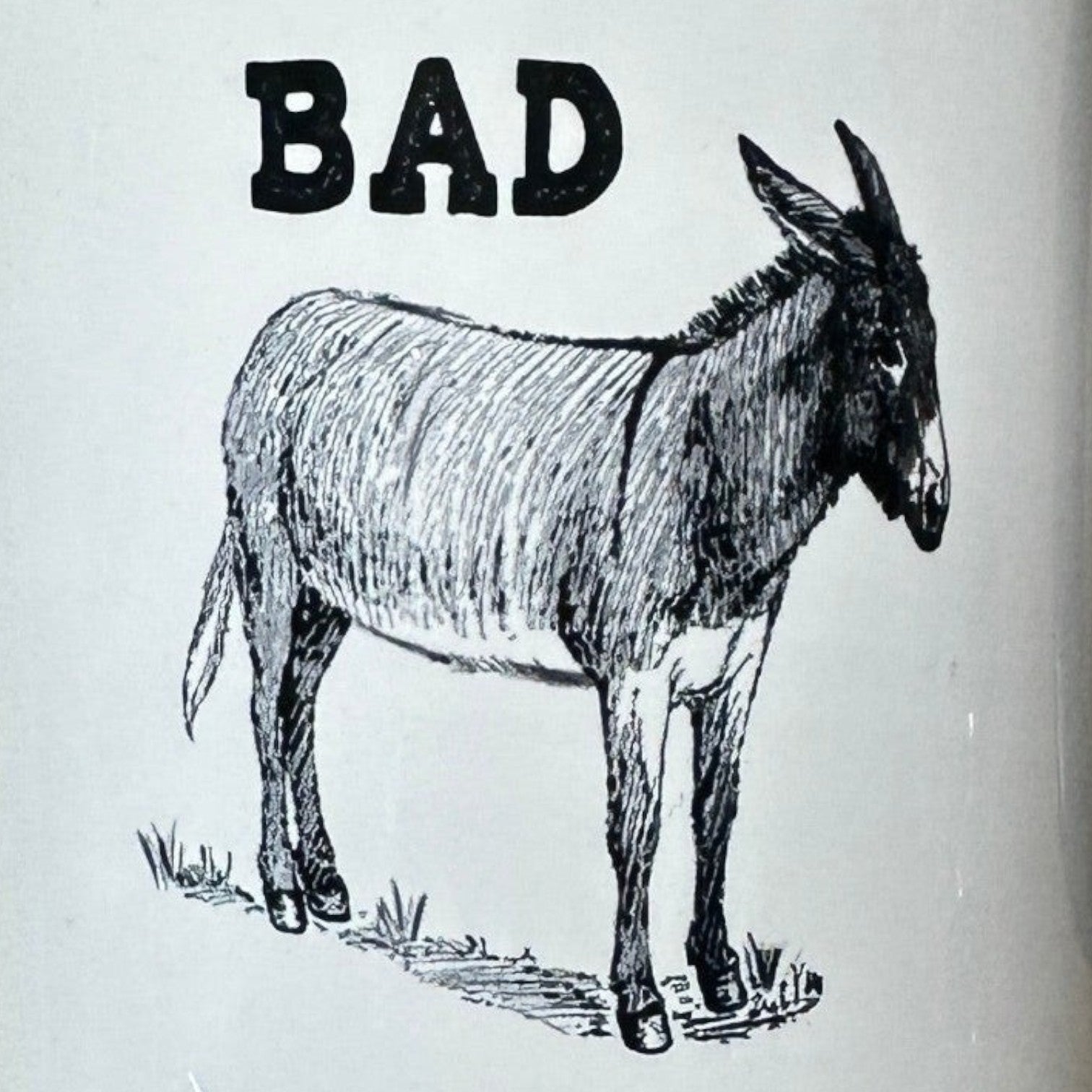 Mellow Monkey black and white ceramic 11-oz mug with "BAD" text and a donkey illustration. Microwave and dishwasher safe.