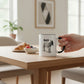 Mellow Monkey white ceramic mug with black trim, featuring the word BAD and a donkey illustration. 11-oz.
