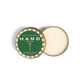 Mellow Monkey Wood Aromatics Balsam Pine hand salve in a round metal tin with a green and gold label.