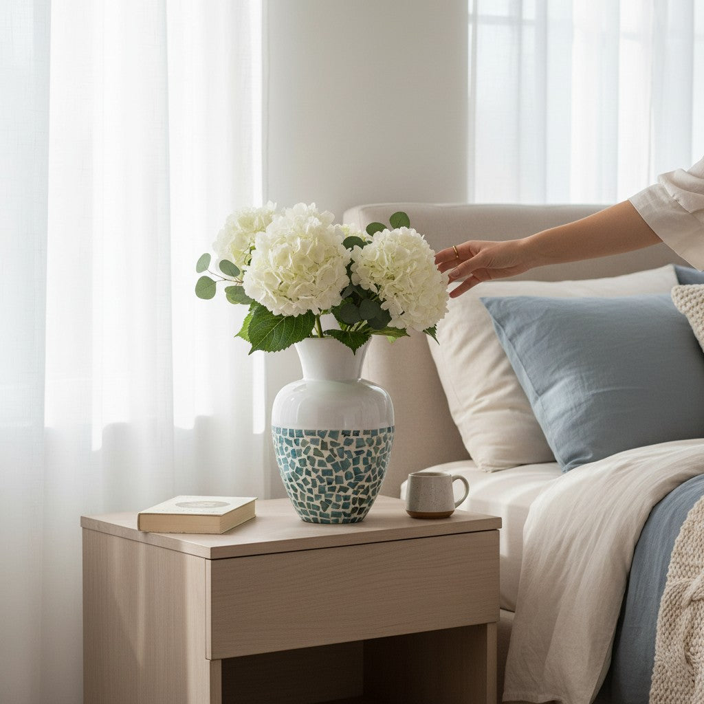 Mellow Monkey 14-inch bamboo and capiz shell vase with blue mosaic base and white top, styled on a bedside table.