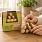 Mellow Monkey Mini Eco Logicals bamboo stacking puzzle being assembled by hand on a wooden table.