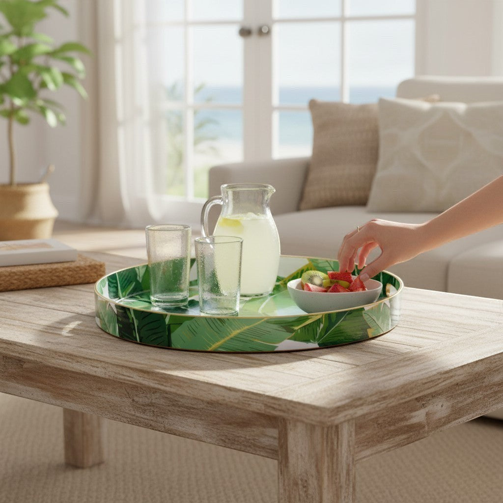 Mellow Monkey banana leaf round resin tray with gold trim, serving drinks and fruit salad. Tropical decor.