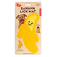 Mellow Monkey yellow banana-shaped silicone lick mat for dogs, features a smiling face and textured surface.