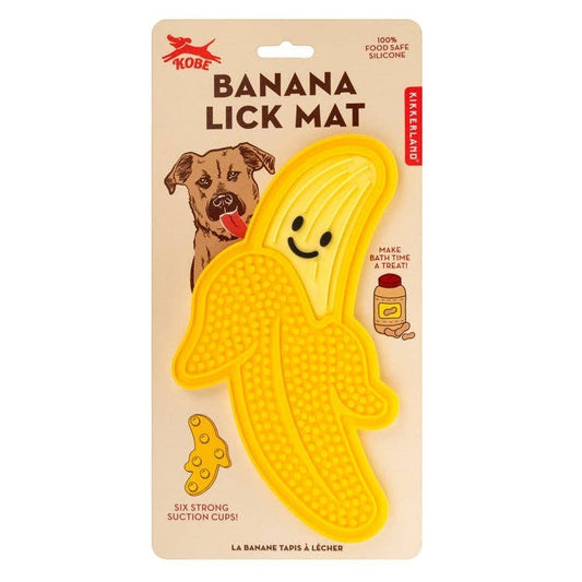 Mellow Monkey yellow banana-shaped silicone lick mat for dogs, features a smiling face and textured surface.
