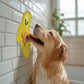 Mellow Monkey yellow banana-shaped silicone lick mat with peanut butter, for dogs.