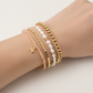 Mellow Monkey Sahara Aurora Borealis bracelet stack featuring freshwater pearls, gold chain, and a star charm.