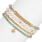 Mellow Monkey bracelet set featuring freshwater baroque pearls, gold chain links, and sea-green crystal beads.