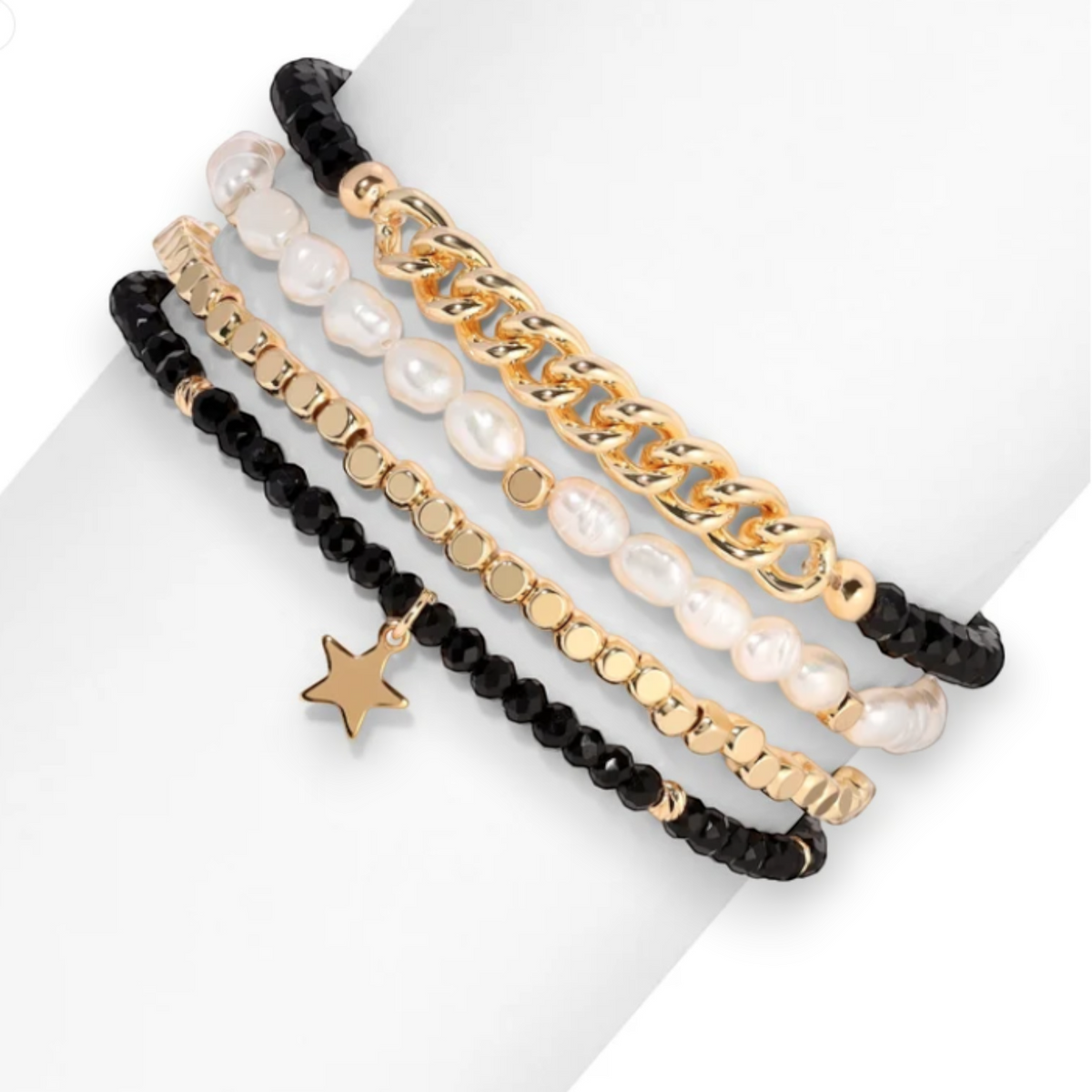 Mellow Monkey bracelet set featuring freshwater baroque pearls, black crystals, gold chain, and a star charm.