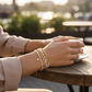 Mellow Monkey bracelet set featuring freshwater baroque pearls, gold beads, and a star charm on a woman's wrist.