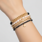 Mellow Monkey bracelet set featuring baroque freshwater pearls, indigo crystals, gold chain, and a star charm.