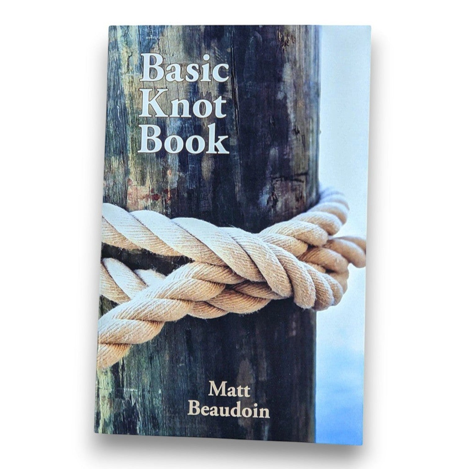 Mellow Monkey Basic Knot Book featuring a rope tied around a wooden post with hand-illustrated instructional content.